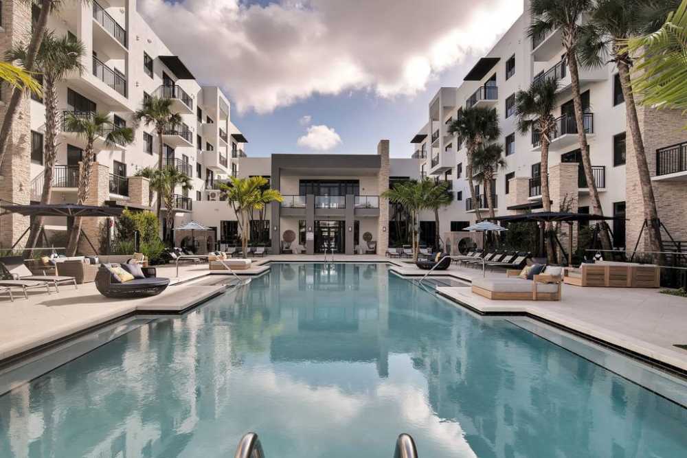 Heated Resort Inspired Pool With Lounge Seating And Grill Stations at Palmera in Doral, Florida