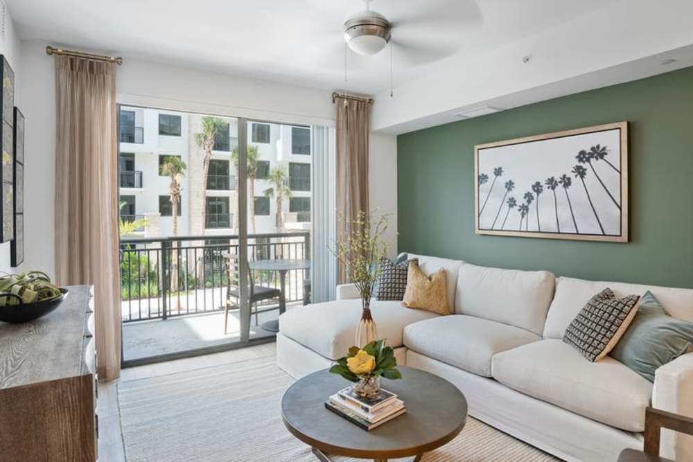 Luxury Apartments In Doral, FL With In-Unit Washer And Dryer - Palmera - Bright Spacious Living Room With Sliding Glass Doors Leading To Private Balcony And Patio Spaces