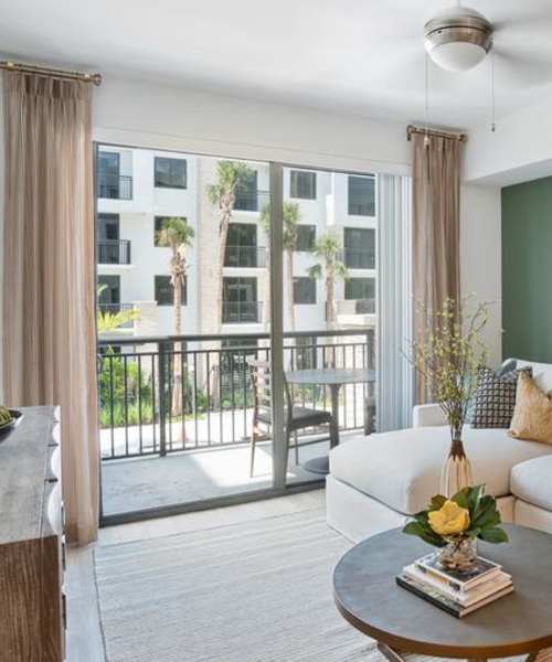 Living room with balcony access at Palmera | Apartments in Doral, Florida